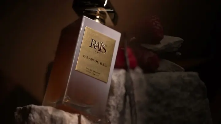 Flacon de parfum Palais du Raïs posé sur une pierre, fond sombre